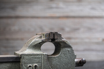 Worn metal bench vise jaws in workshop close-up
