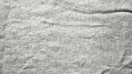 wrinkled gray ribbed fabric closeup with horizontal ridges abstract texture unfolding subtle folds for wallpaper background or banner copy space © Arthur