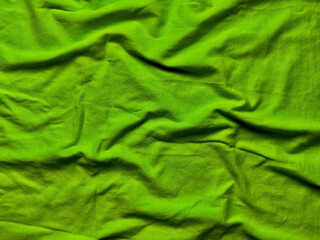 vibrant lime green wrinkled cotton fabric texture with soft folds and ripples ideal for seamless backgrounds or digital wallpapers