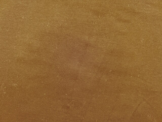 warm brown corduroy fabric texture closeup revealing subtle ridges and earthy gradients ideal for vintage wallpaper or design backdrop