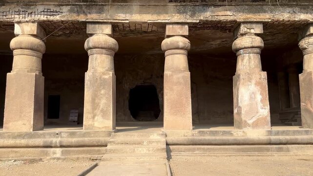 Rock-cut temple colonnade at Elephanta Caves on Elephanta Island, Mumbai Harbor, Maharashtra, India.
