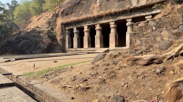 Rock-cut temple colonnade at Elephanta Caves on Elephanta Island, Mumbai Harbor, Maharashtra, India.
