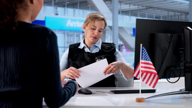 Woman At US Border Control At Airport Giving Her Passport