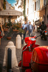 Red scooter parked on a vibrant street in a bustling city, capturing the essence of urban life. Rome Italy © guteksk7