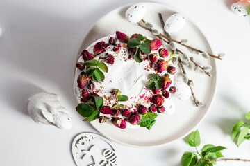 Festive Easter Kulich сake with rose petals and spring decorations