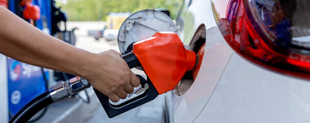 Man Refill and filling Oil Gas Fuel at station. Gas station - refueling.