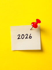 a sticky note with 2026 text on yellow background