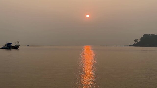 Sunset over the Arabian Sea in Panaji Goa India, calm coastal landscape at dusk
