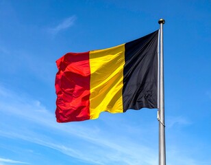 Belgian Flag Flying Against Blue Sky