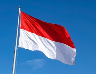 Indonesian Flag Waving Against Clear Blue Sky
