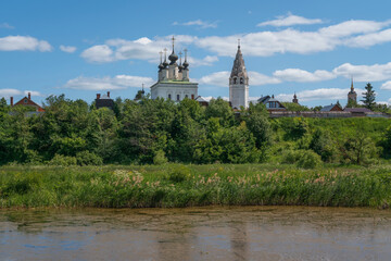 Church of the Ascension of the Lord with a bell tower in the Alexander Monastery on the banks of the Kamenka River on a sunny summer day, Suzdal, Vladimir region, Russia