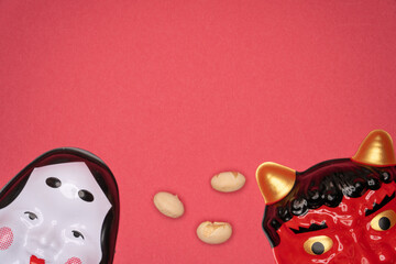 Japanese demon and smiling masks with soybeans on red background