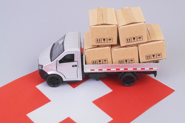 Lorry truck with many boxes on flag of Switzerland.