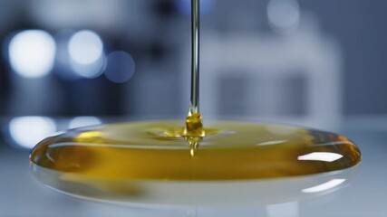Biotech Investment Trends concept. Golden liquid dripping onto a smooth surface.