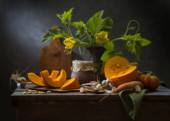 Still life with pumpkin and vegetables on a dark background