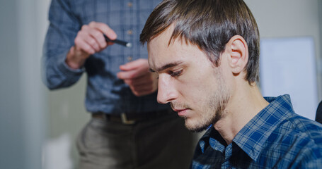 Team adult male engineer collaborate on robotic hand project using AI code solutions machine learning at tech workspace. Artificial intelligence interface, collaboration support prototype development.