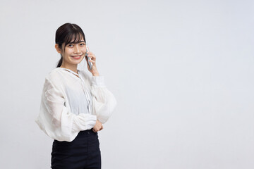 Smiling Young Woman Talking on Smartphone Against White Background