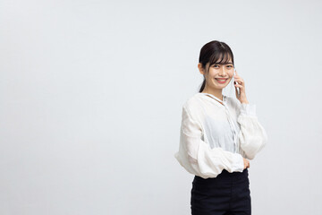 Smiling Young Woman Talking on Smartphone Against White Background