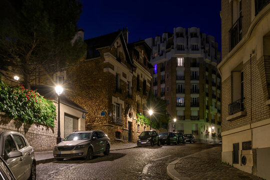 Cozy street in quarter Montmartre in Paris, France. Architecture and landmarks of Paris. Postcard of Paris. Night cityscape of Paris