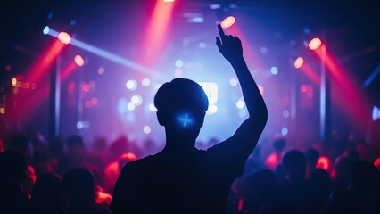 Young man celebrating success at vibrant concert with colorful lights
