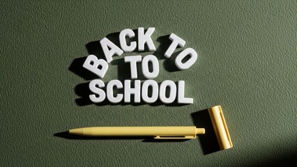 Back to School" text with pen on textured green surface