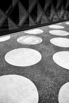 Modern abstract urban pavement with circles pattern and geometry showing rich texture design and high contrast creating a graphic background