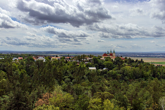 Aerial view of Svat&yacute; Kopeček Basilica near Olomouc. Baroque church on a hill surrounded by green forests, Czech landscape under cloudy sky for travel and religious projects.