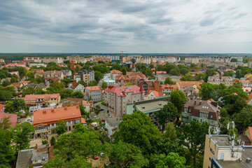 Obraz premium Aerial view of Zelenogradsk city cityscape with historic red roof buildings and old water tower under cloudy sky in Kaliningrad region Russia
