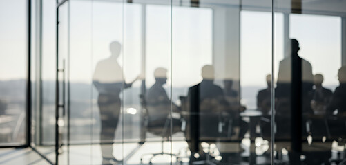 Fototapeta na wymiar Blurred figures in a conference room create a sense of motion and purpose, highlighting leadership, negotiation, and productivity inside a sleek workplace overlooking the city skyline.