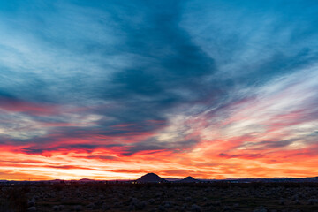 Desert Glow: Sunset Clouds Racing Across the Mojave Horizon