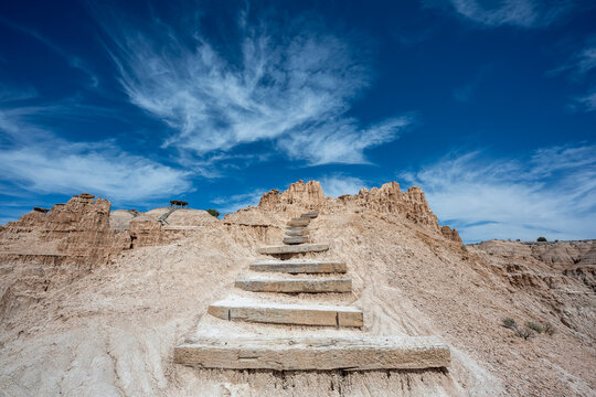 Blue skies over rocky desert steps exiting the Cathedral Gorge in Nevada 