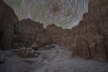 Spinning Star trails over a jagged rock walk in rural Nevada 