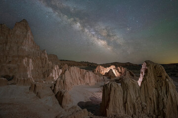 Illuminated desert rock formations in Nevada under a clear starry night sky 