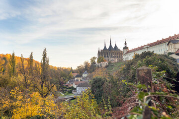Happy family with children and dog in Kutna Hora, Czech Republic, visiting the town on an autumn sunny day