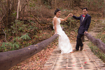 Portrait Wedding on bamboo bridge Asia Thai people