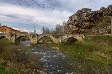 Fototapeta premium Historic stone bridge over the Pisuerga River in Cervera del Pisuerga