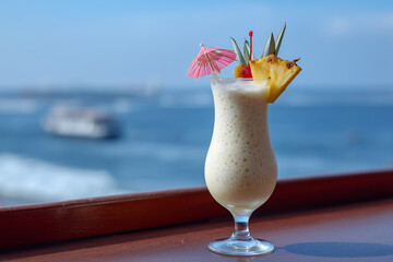 Refreshing Pineapple Milkshake in Tall Glass with Fresh Fruit Garnish - Tropical Summer Drink