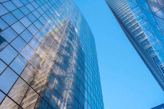 Modern paris city architecture skyscraper with glass facade window mirror reflection in bright sky for corporate office building background