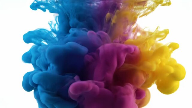 Vibrant cyan, magenta, and yellow inks slowly mix in water. Beautiful abstract colors create a dynamic and fluid background.
