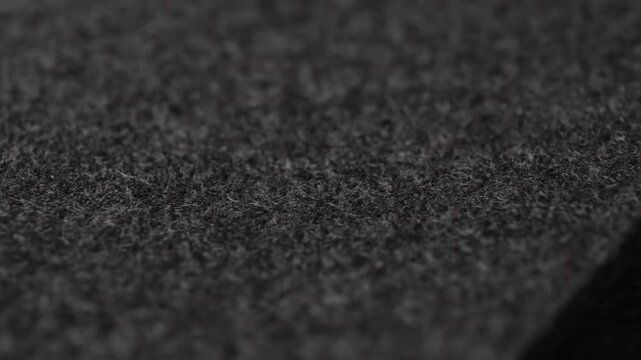 Close-up of a dark gray textured surface with a black corner