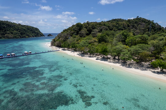 Tropical paradise white sand beach with palm trees on Koh Rok, Mu Ko Lanta National Park.