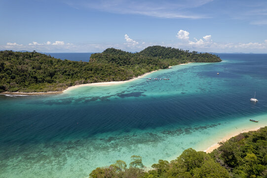 Tropical paradise white sand beach with palm trees on Koh Rok, Mu Ko Lanta National Park.