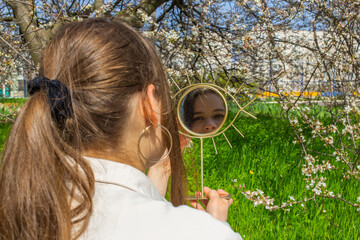 Young woman looking at herself in the mirror