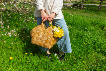 Young woman holding a basket filled with daffodils