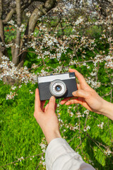 Hands holding a camera in the street