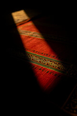 Golden Light on Prayer Rug in Dark Room Ramadan Kareem Devotion, Jumma Mubarak Solitude, Sacred Moment of Worship