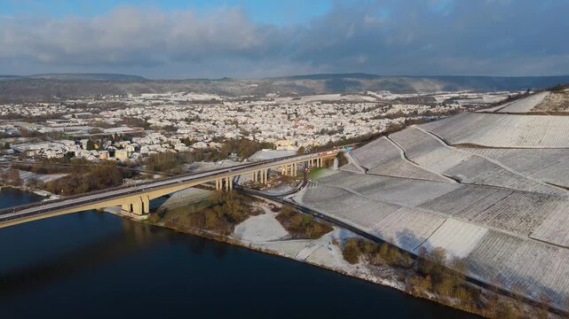 Snow covered Moselle valley, vineyard and Mosel river, Viaduct Longuich bridge of highway crossing near Trier, aerial view, winter season with frost in Germany