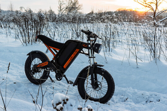 Rugged electric fat bike stands proudly in a serene, snow-covered winter landscape, ready for off-road adventure and thrilling rides through frozen trails: Russia - January 18, 2026