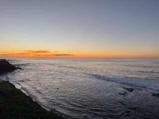 Fototapeta premium A beautiful and peaceful sunset casting warm light over the Pacific Coast in La Jolla, San Diego.