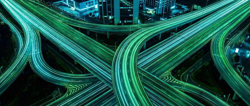 Generative AI illustration of a neon green highway interchange at night with futuristic light trails.